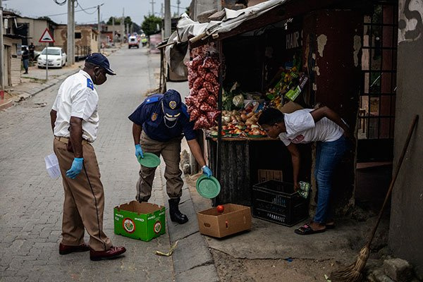 Johannesburg Metro Police Department (JMPD) officers confiscate goods from an informal trading pos