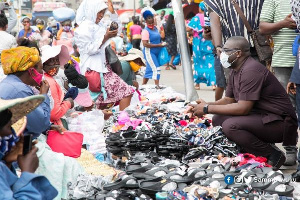 Sammi Awuku, National Organizer,  New Patriotic Party interact with market women