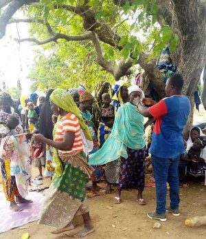 Sections of Burkinabe nationals in Sissala East being screened by officials of Ghana Health Service