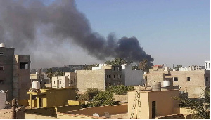 Smoke rises amid clashes between armed factions in Tripoli, Libya on August 15, 2023.