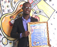 Ebenezer Kewaw Madugu with his plaque