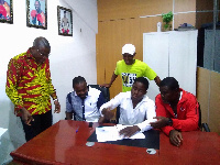 Derek Quaye signing the deal