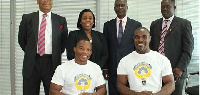 Two executive members of G0-Get-Dem Wheelchair Racing Club in a picture with officials of GCB