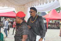 Actor Hanks Anuku in spectacles with a mourner at the funeral rites