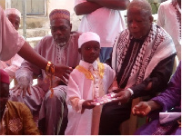 Jawad Ibrahim receiving a Quran from the Chief Imam