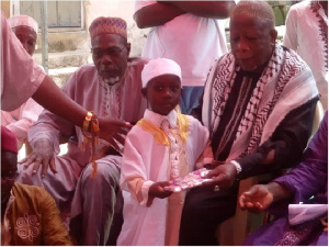 Jawad Ibrahim receiving a Quran from the Chief Imam