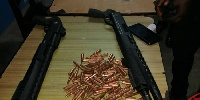 The pump-action shotguns and 100 rounds of AK-47 ammunition retrieved by the police