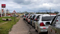 Motorists queue for petrol at a fuel service station on the outskirts of Harare, Zimbabwe