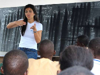 CEO of Tigo, Roshi Motman with some school kids