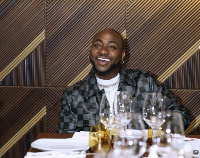 Davido smiles as he cashes in money in 2021