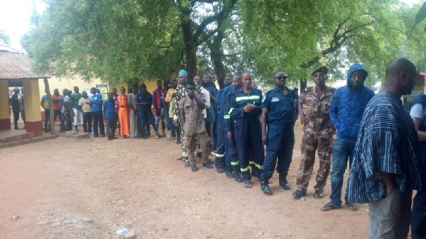 Some security officials in a queue to vote