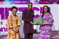 Minister of Communications, Mrs. Ursula Owusu-Ekuful receiving an award at  FEMITECH Conference