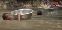 Children in Agorde put their uniforms and books in basins as they swim their way through two rivers