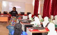 Asiedua Addae, Head of Corporate Affairs, Brand & Marketing speaking to some students