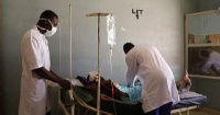 Medics attend to a patient in a hospital