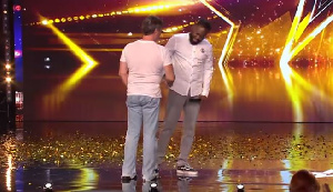 Simon Cowell shakes Kojo's hand after giving him the Golden Buzzer