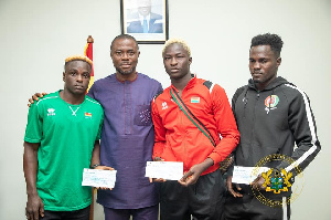 Deputy sports minster, Opoku Bobie with the three boxing medalists