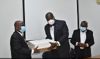 Mr Anthony Forson (middle) presenting the two laptops to Legal Aid Commission boss, Martin T. Ameyaw