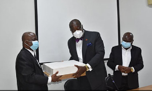 Mr Anthony Forson (middle) presenting the two laptops to Legal Aid Commission boss, Martin T. Ameyaw