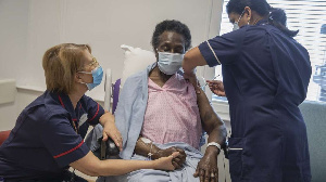 Dilhani Somaweera administers the Pfizer-BioNTech Covid-19 vaccine to Josephine Faleye