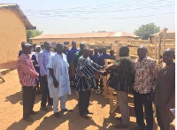 Issah Musah presenting the furniture to officials of GES