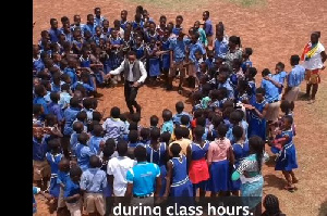 Sackey Percy dances in a circle with his students