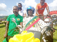 The overall best farmer in Obuasi in his tricycle