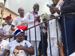 Annor Mensah flanked by some supporters at the party premises