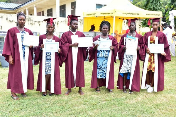 Some of the graduates displaying their certificates after the graduation ceremony