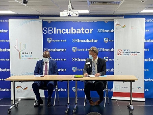 (Leff) Kwamina K. Asomaning and (Right) Gerald Guskowski during the signing