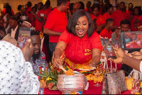 Nana Ama Macbrown, Brand Amb. of Tasty Tom Jollof Mix samples freshly cooked Jollof