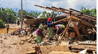 Citizens try to save their belongings after landslides triggered by heavy rains in Rubavu, Rwanda