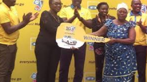 Madam Rebecca Quaye being presented with the car key