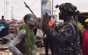 Fetish priest facing off with a policeman