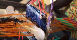 An artisan weaving the Kente cloth