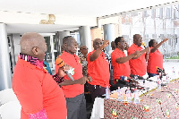 Dr Yaw Baah(second from right) and other executives chanting a solidarity song at the conference