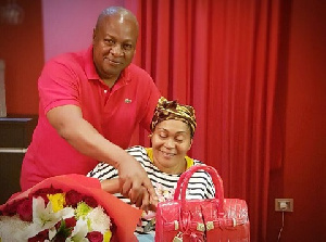 Romantic John Mahama helping wife to cut the cake