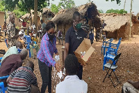 The DCE and her team distributing sanitizers to some rural folks