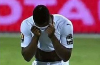 Ekuban (face covered) in tears after missing his penalty