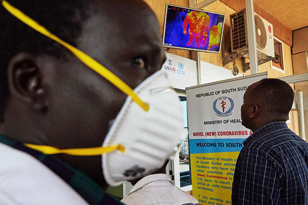 Passengers from an international flight are screened for their temperature, | ALEX MCBRIDE | AFP