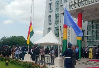 Mr Thomas Mbomba (L) and Mr Charles Abani (R) hoisting flags of Ghana and UN