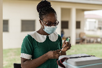 A nurse prepares to administer a coronavirus shot