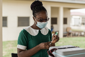 A nurse prepares to administer a coronavirus shot