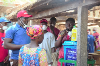 The team educating market women on how to properly wash hands