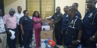 Madam Adwoa Amoako presenting items worth GHC200,000 to the Baatsonaa Divisional Police command