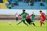 Arafat Mensah in a green jersey