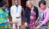 USAID Country Director (2nd R) and Gender Minister (R) interact with some exhibitors