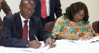 Makove and Lariba Bawa simultaneously signing the MoU