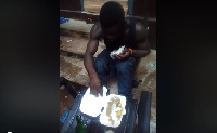 The young man struggling to eat a ball of banku