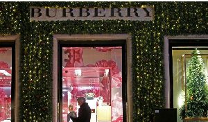 Festive lights decorate the Burberry store on New Bond Street as shoppers do Christmas shopping